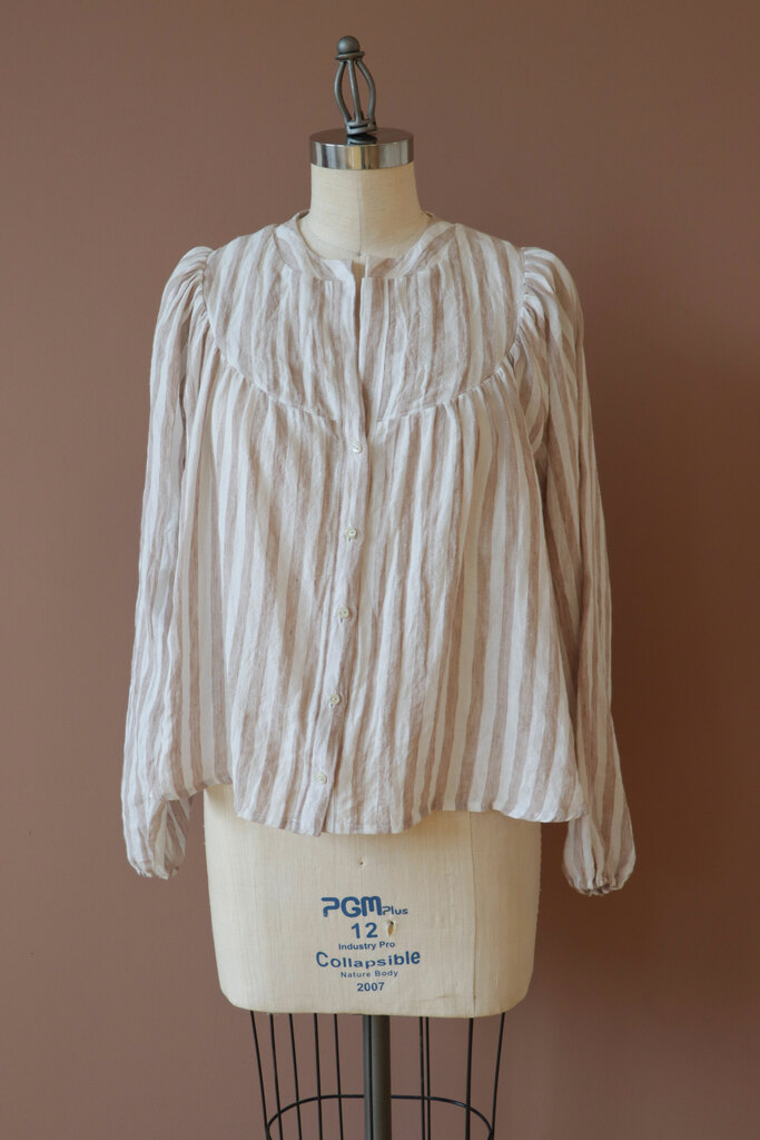 aims dress in cotton linen, showing less drape