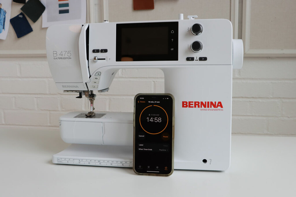 A timer next to a sewing machine