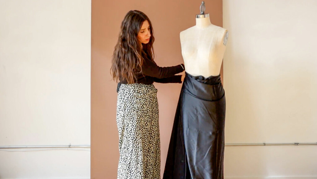 sarai draping black silk on a dress form